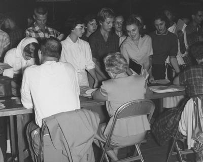 Registration--from left to right: unidentified, unidentified, Emily Crawford, unidentified, Belinda Clark, unidentified, and others. Received September of 1957 from Public Relations