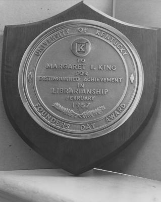 Picture of a plaque awarded to Margaret I. King, first librarian at UK; award given February 22, 1957 on Founders' Day. Received January 31, 1957 from Public Relations