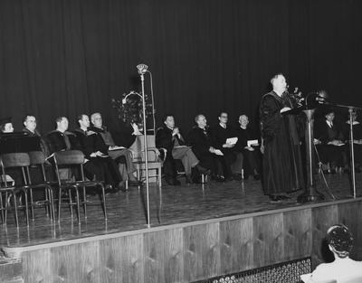 President Donovan a the dedication of the Fine Arts Building at the Guignol Theater. From left to right: Helen King, L. S. Thompson, E. E. Stein, H. E. Spivey, F. L. McVey, R. McLain, L. M. Chamberlain, unidentified man, Ezra L. Gillis, Jack Wild, and W. N. Wally Briggs. Photographer: John B. Kuiper