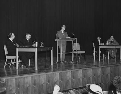 A. B. Gutherie speaking at Guignol Theater during Founder's Week. Seated around Gutherie, from left to right: William Sloane, John Ciard, Jesse Stuart and Professor Hollis S. Summers. Photographer: John B. Kuiper