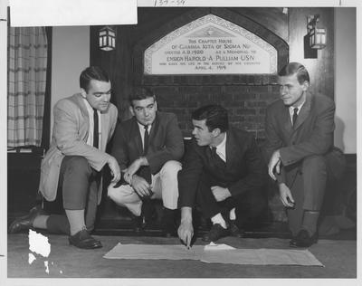 Sigma Nu officers discuss pros and cons of moving to a new house. From left to right: Steve Scott, Jerry Miller, John Cowgill, Hale Cochran. Received March 16, 1964 from Public Relations. Photo appears first on page 137 in the 1963 Kentuckian