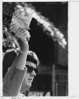 An unidentified man holds up bid cards during fraternity Rush. This photo appears first on page 8 in the 1969 Kentuckian