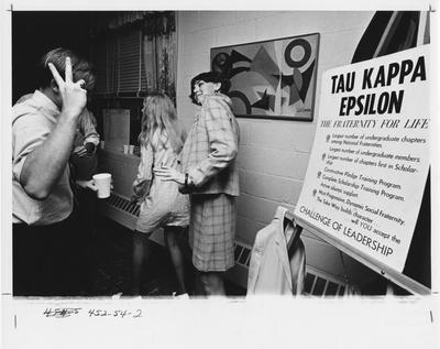 Tau Kappa Epsilon fraternity; couples dancing, socializing, holding cups, and smoking cigarettes. This photo appears second on page 54 in the 1969 Kentuckian