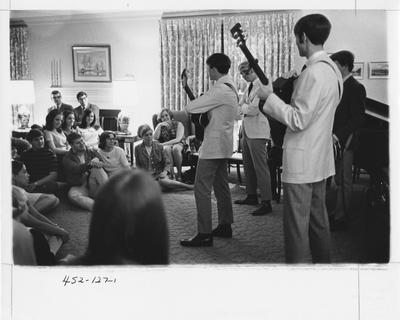 A sorority function; members of an unidentified band plays to a group of students. This photo appears first on page 127 in the 1969 Kentuckian