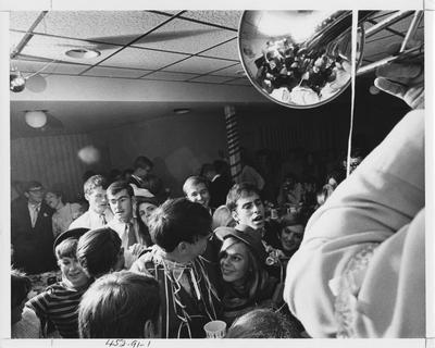 Students socialize at a fraternity party. This photo appears first on page 91 in the 1969 Kentuckian