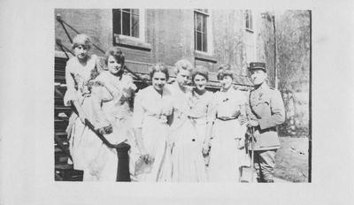 Seven unidentified people standing in front of the Administration Building. This photo was accessioned on January 3, 1966 from the Administration Building