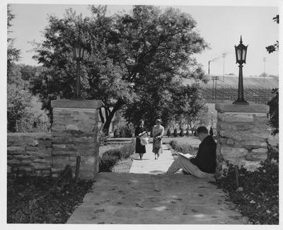 Susan Haselden (right) is talking to Lind Hurst (left) while an unidentified man is reading