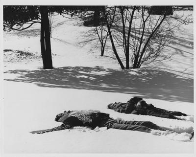 Students lying in the snow