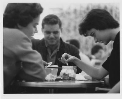 Three students sitting around a table; far right, Dana Terrell