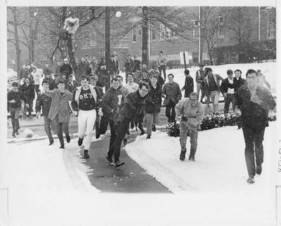Unidentified students are throwing snowballs and playing in the snow on UK's campus. This photo appears second on page 87 in the 1969 Kentuckian