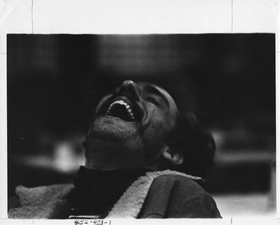 An unidentified male student is laughing. This image appears first on page 433 in the 1969 Kentuckian