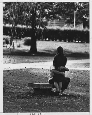 Two unidentified students are hugging in the Botanical Gardens. This photo appears first on page 65 in the 1969 Kentuckian
