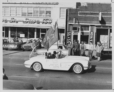 Homecoming Parade in downtown Lexington. Sigma Alpha Epsilon fraternity in a corvette with 
