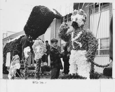 People decorating a Homecoming float. This image appears first on page 79 in the 1969 Kentuckian