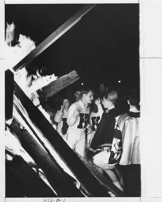 UK cheerleaders at a homecoming bonfire. Appears first on page 80 in the 1969 Kentuckian