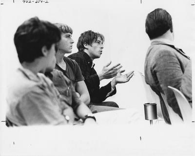 Five unidentified people, one is speaking at a Community Alliance for Responsible Action (C.A.R.S.A) meeting. This image appears second on page 255 in the 1969 Kentuckian