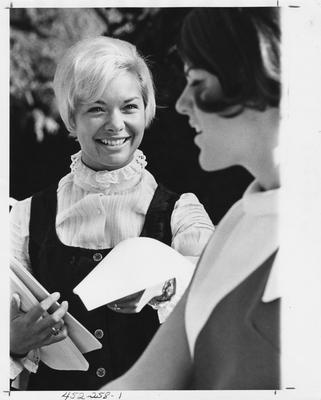 An unidentified female member of the CARSA is handing out a flyer to and unidentified student. This photo appears first on page 258 in the 1969 Kentuckian