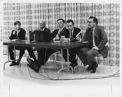 Human Relations Board; five men sitting at a table with three microphones. This image appears first on page 246 in the 1969 Kentuckian
