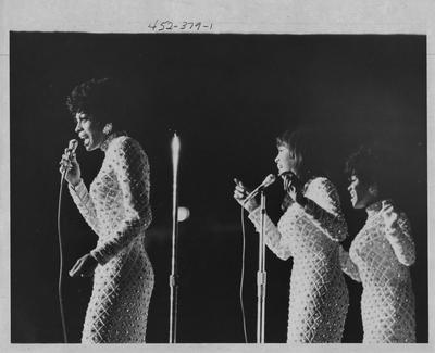 Diana Ross (left) and the Supremes sing at a concert on the University of Kentucky campus; the Student Center Board brought the Supremes to UK; This photo is in the 1969 Kentuckian on page 379, picture number 1