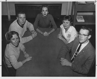 Three girls and two guys sitting at a table; K - Book (student handbook) Staff 1958; This photo is in the 1958 Kentuckian on page 281, picture number 4; Left to Right: Nancy Meadows, Grady Selbards, Jane Harrison, Jean Weatherford, Bob Owen; Photographer: University of Kentucky