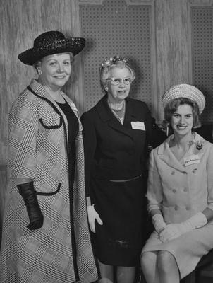 Alpha Xi Delta, which in 1907 became the first national sorority at the University of Kentucky, has state day observance in Lexington in March 1963; From left to right are: Ayleene Hobday (Mrs. H. H. Whitehead), Anna Jean Smith (Mrs. E. Everett Elsey), and Joyce Beals (Mrs. H. E. Wetherton, Jr.); This image is in the 1965 May 9 Lexington Herald - Leader; Lexington Herald - Leader staff photo