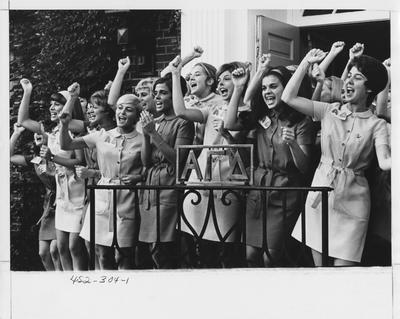 Alpha Gamma Delta sisters cheering; This image is in the 1969 Kentuckian on page 304, image 1