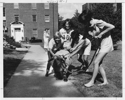 Alpha Gamma Delta sisters holding a sheep in front of the sorority house; This photo is in the 1969 Kentuckian on page 305, picture number 1
