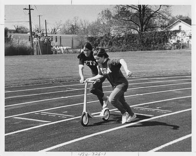 Zeta Tau Alpha sisters in a scooter relay; This image is in the 1969 Kentuckian on page 326, image 1