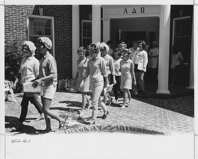 Girls in rollers going to sing in front of the Alpha Delta Pi house; This image is in the 1969 Kentuckian on page 16, image 1