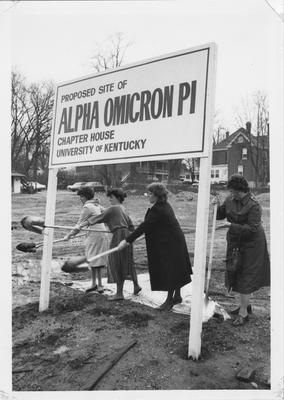 Women shoveling dirt at the groundbreaking for the Alpha Omicron Pi Chapter house at the University of Kentucky