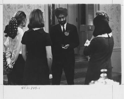 Pritam Sabharwal, Assitant Professor of Botany at the University of Kentucky stands talking to for sorority sisters; This photo is in the 1969 Kentuckian on page 349, picture number 1