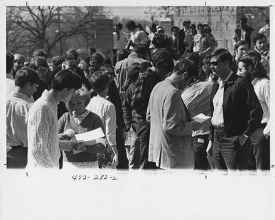Students passing out letters; This image is in the 1969 Kentuckian on page 282, image 2
