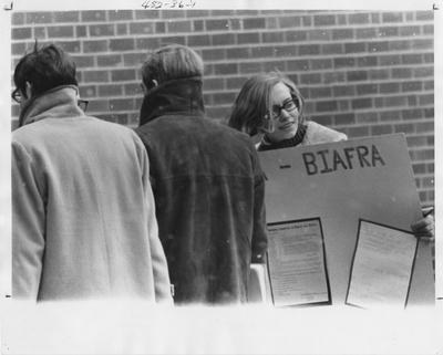 Student holds up a poster during Winter Virgil; This image is in the 1969 Kentuckian on page 36, image 1
