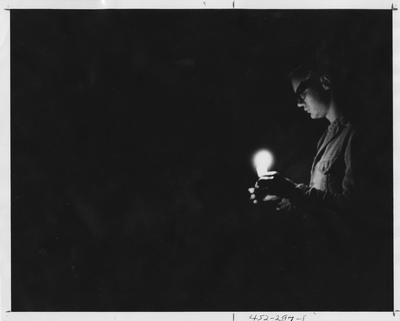 Student lighting candle; This image is in the 1969 Kentuckian on page 297, image 1