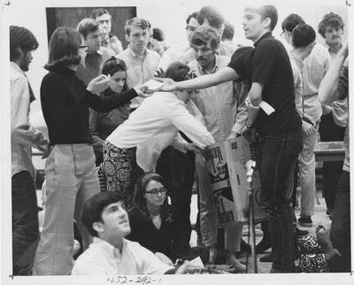 Students passing out food at a protest; This image is in the 1969 Kentuckian on page 292, image 1