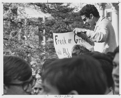 Male student holding a poster during a protest; This image is in the 1969 Kentuckian on page 284, image 2