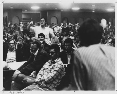 Male student stands to speak during a protest; This image is in the 1969 Kentuckian on page 286, image 2