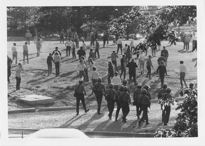 Armed guards follow the crowd of protesters during a reaction to the Kent State shootings