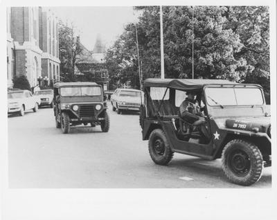 Army Jeeps drive past the Administration Building during the reaction to the Kent State shootings