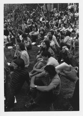 Protesters of the Kent State shootings sit listening in the grass