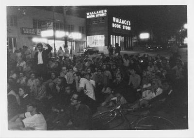Students sit in the middle of Limestone St. near Wallace's Book Store at night to protest the Kent State shootings