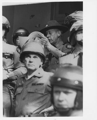 Kentucky state police and United Stated Army soldiers standing in a doorway during a protest in reaction to the Kent State shootings
