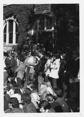 Kentucky state police stand in the doorway of Barker hall while students protest in reaction to the Kent State shootings