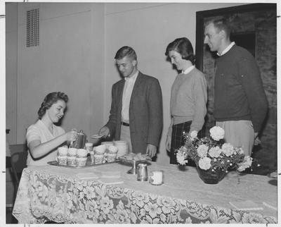 John Davis (third from right), Carolyn Jones (second from right), Gregg Rhodemyre (second from right), and an unidentified female student at a tea party in the Student Union Building