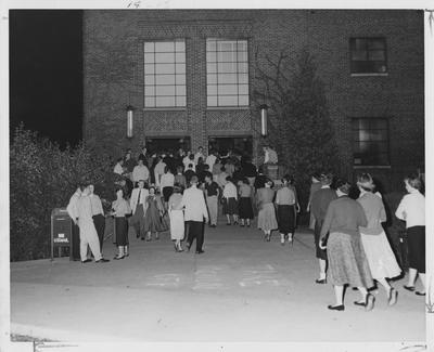 Students going into a dance at the Student Union Building; This photo is in the 1957 Kentuckian on page 14, image 1