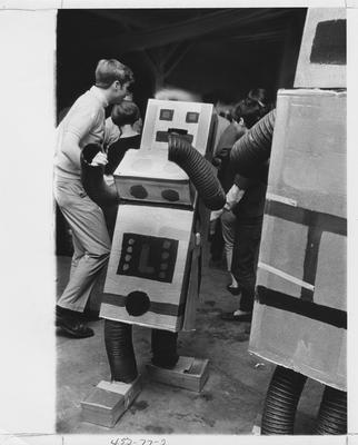 Students dance with cardboard robots at the Beaux Arts Ball; This photo is in the 1969 Kentuckian on page 77, picture number 2