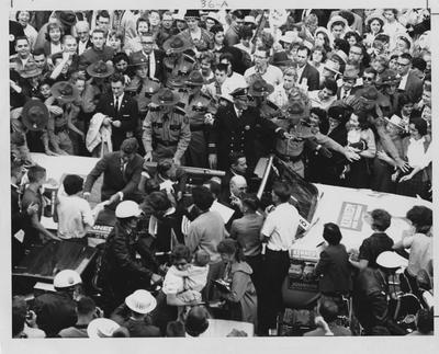 John F. Kennedy riding with Governor Bert Combs during a campaign visit to the University of Kentucky's campus