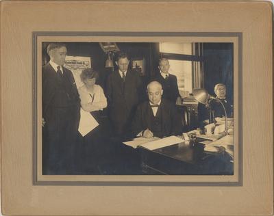 Governor A. O. Stanley signs a $200, 000 appropriations bill; Standing left to right: President Frank L. McVey; Miss Mahler; Richard C. Stoll, member Board of Trustees; Senator D. H. Peak; Treasurer John Shane