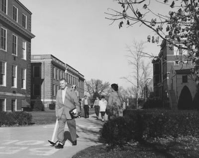 Students walking to class; McVey Hall and Journalism building are on the left; Library, Pence Hall, and the temporary Chemistry building are on the right