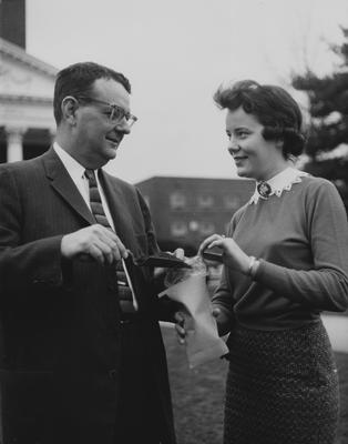 Dr. Stanley Wall, associate dean of the College of Agriculture and Home Economics, and his secretary, Peggy McCarthy, sack up a bit of genuine Kentucky bluegrass soil for shipment to South Dakota State College at Brookings for use in Arbor Day ceremonies